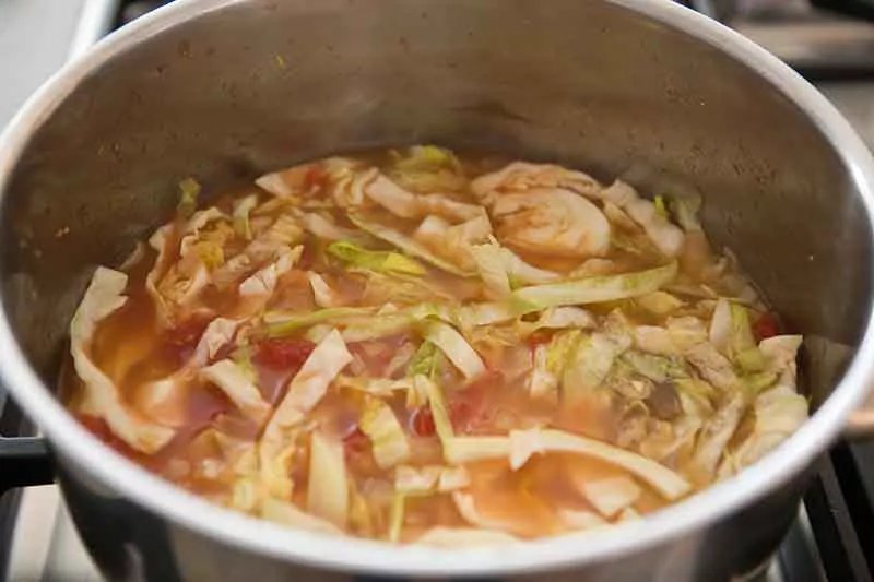 Cabbage soup in stock pot ready to boil